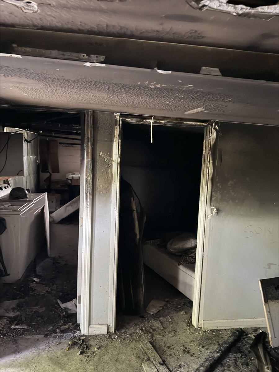 Damaged doorway and laundry area before demolition